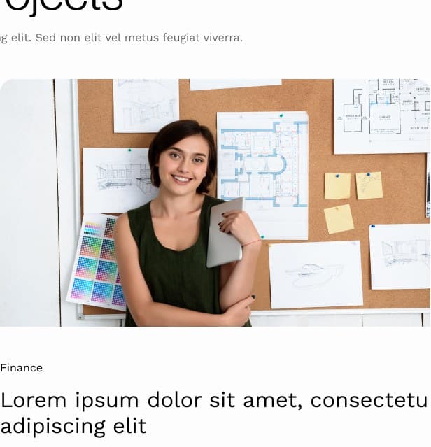 Designer holding a tablet in front of planning boards.