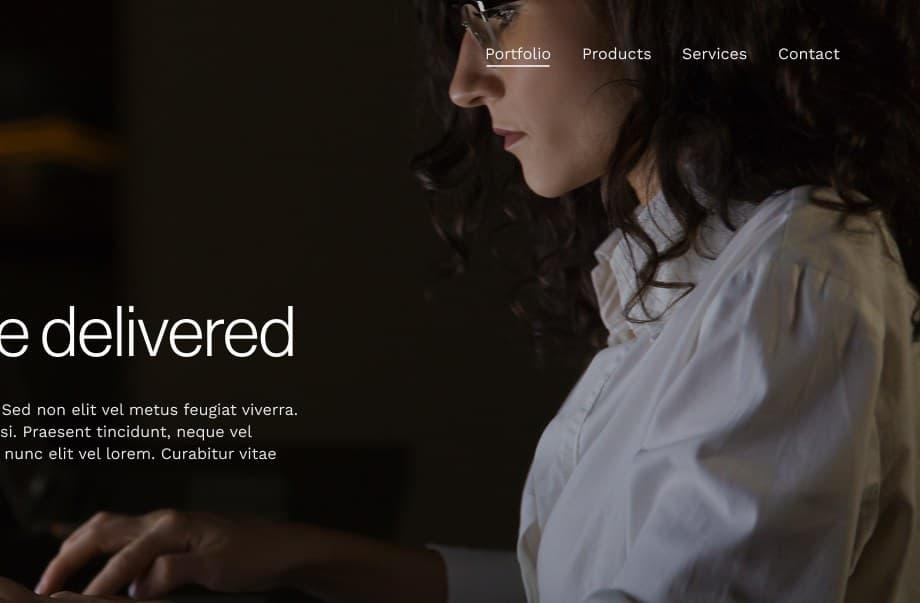Professional working at a computer in low light.