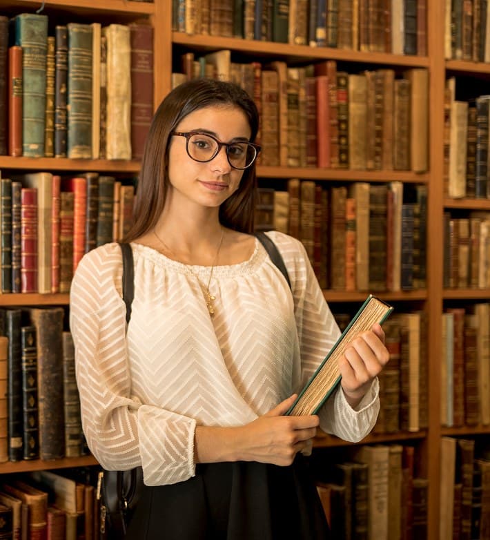 Reader standing in a library.