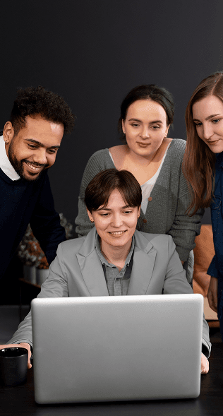 Product team gathered around a laptop.